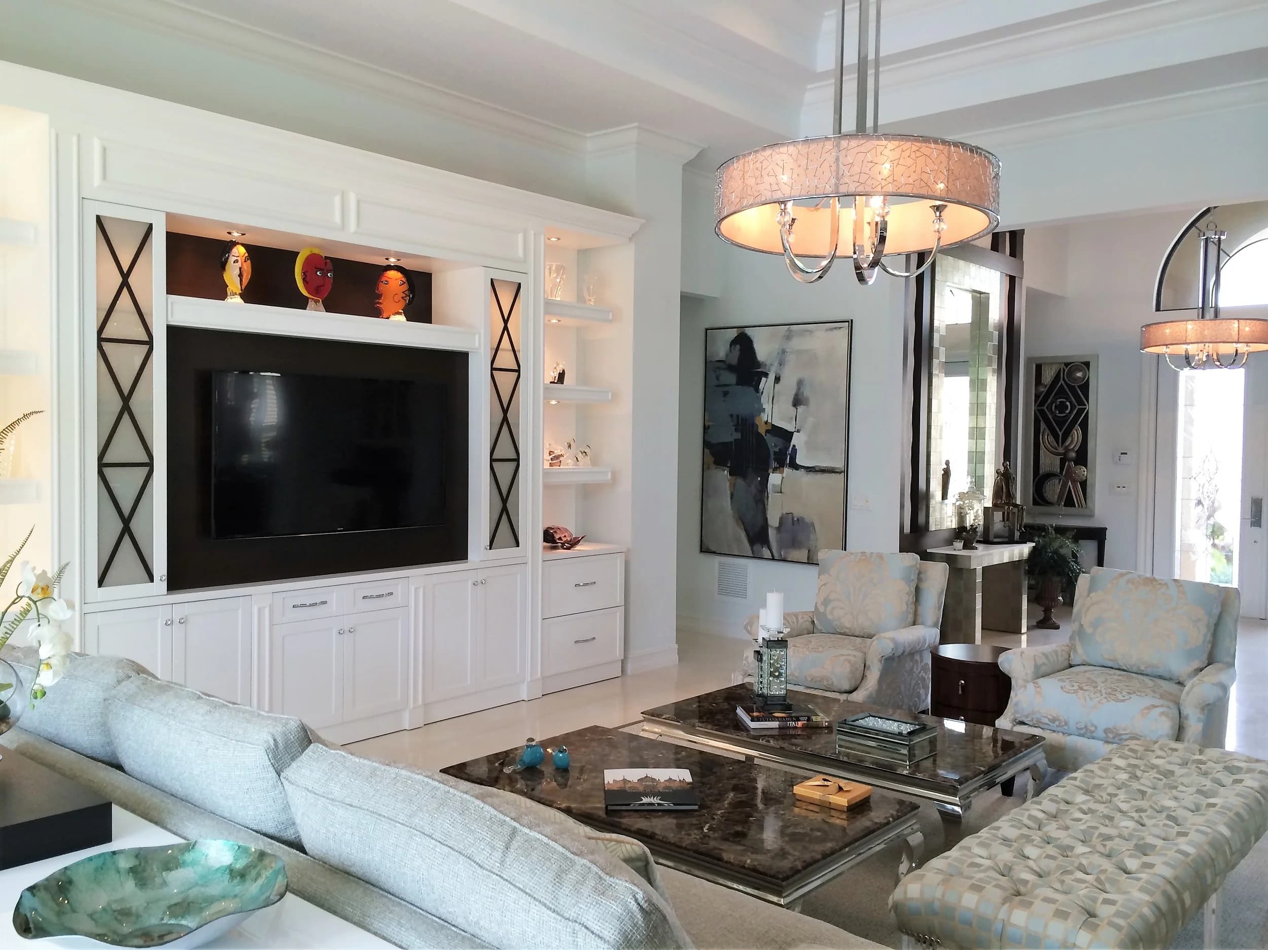 Flat-panel display recessed into custom white millwork in a formal living room