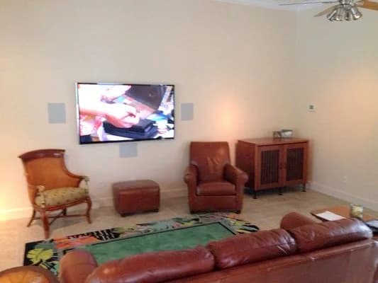 Living room with a wall-mounted display and flush in-wall speakers