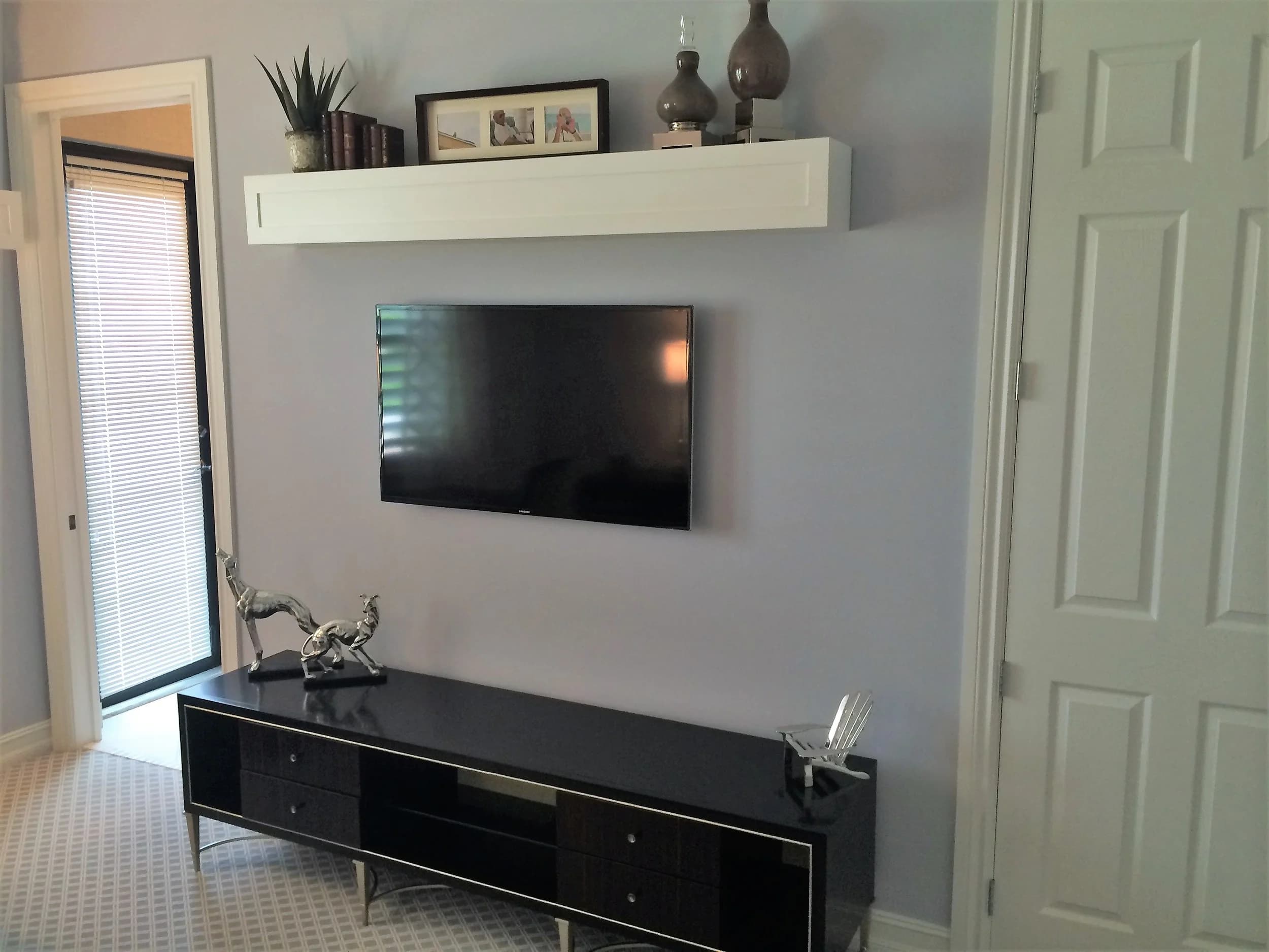 Minimal wall-mounted display and soundbar on a floating console