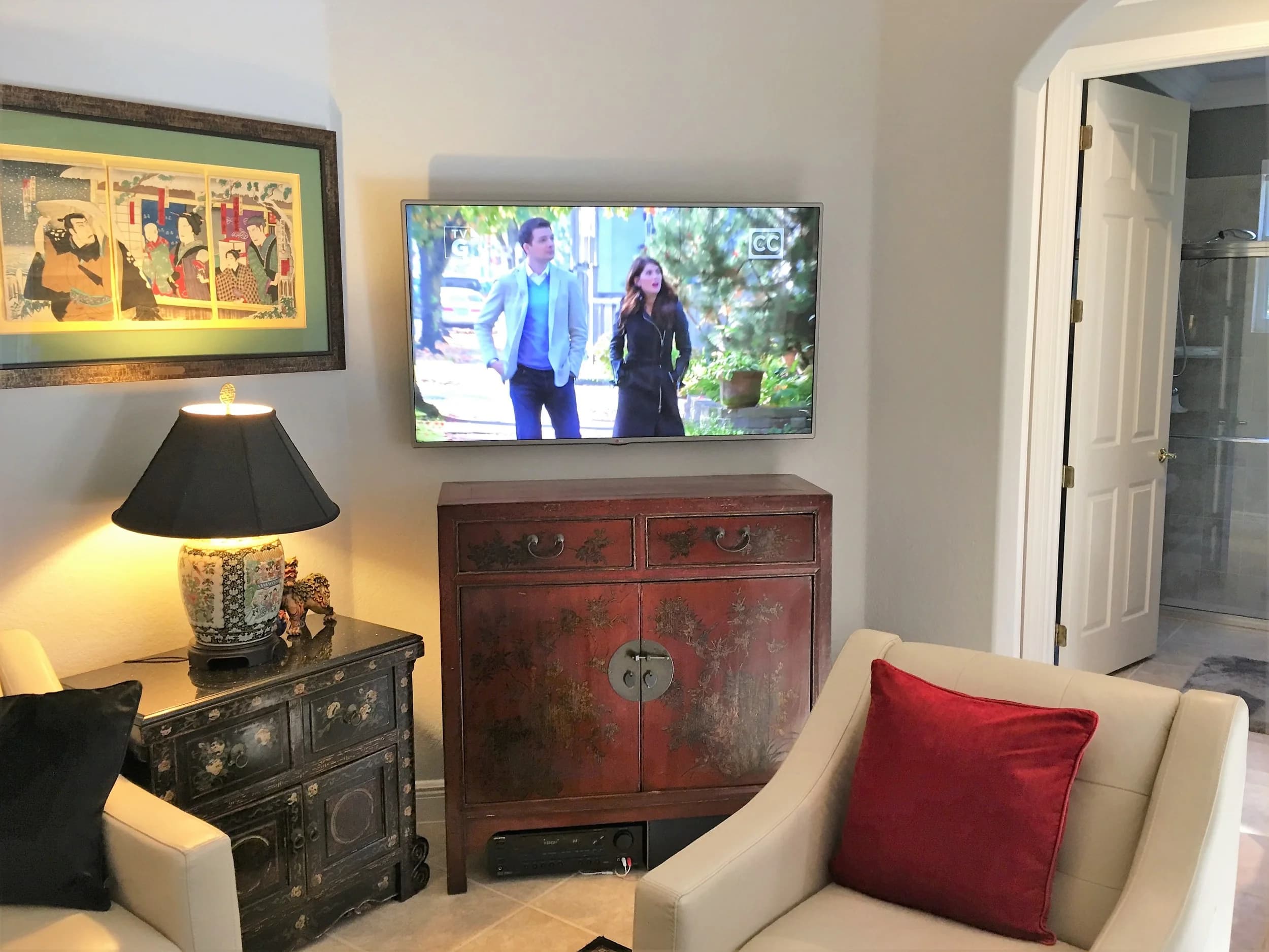 Flat-panel display wall-mounted above a console with concealed wiring